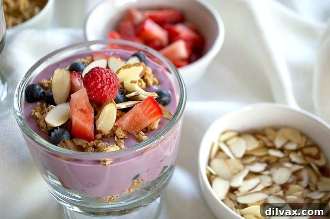 A close-up shot of a homemade breakfast parfait, showcasing the layers of fresh ingredients and healthy toppings, ready to be enjoyed.