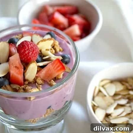A beautifully assembled breakfast parfait with layers of yogurt, fruit, and granola, showcasing a healthy morning meal.
