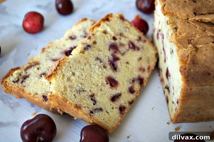 Overhead shot of a beautifully baked Cherry Pound Cake, garnished with fresh cherries.