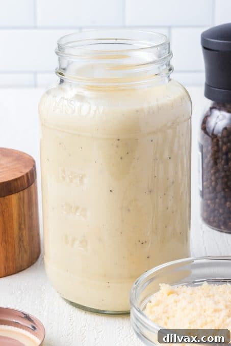 Creamy Sausage Alfredo Rigatoni 6 Close-up of creamy Roasted Garlic Alfredo Sauce in a saucepan
