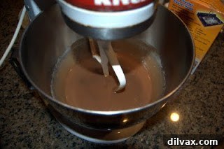 Velvet Nutella Sour Cream Cookies 2 Creamy mixture of eggs, sugar, sour cream, Nutella, butter, and vanilla in a mixing bowl.