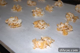 Portioning cookie dough onto parchment-lined baking sheet
