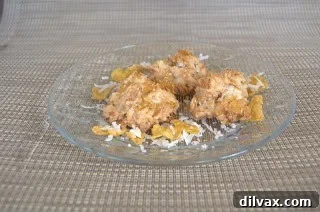 Freshly baked Cornflake Macaroons cooling on a wire rack, showing their golden brown edges.