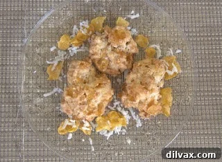 A close-up shot of a single, perfectly baked Cornflake Macaroon, highlighting its unique texture.