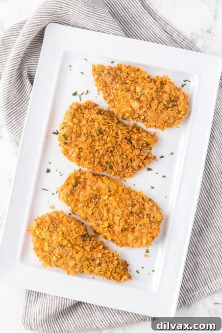 Baked chicken breasts coated in a corn flake mixture.