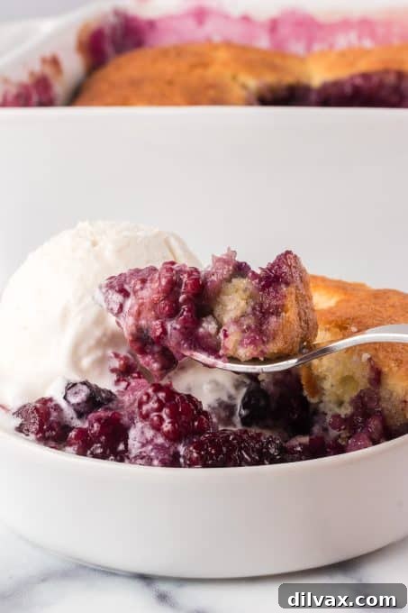 Rustic Berry Bake 10 A close-up of a spoonful of Berry Cobbler, showing the juicy berry filling and tender topping.