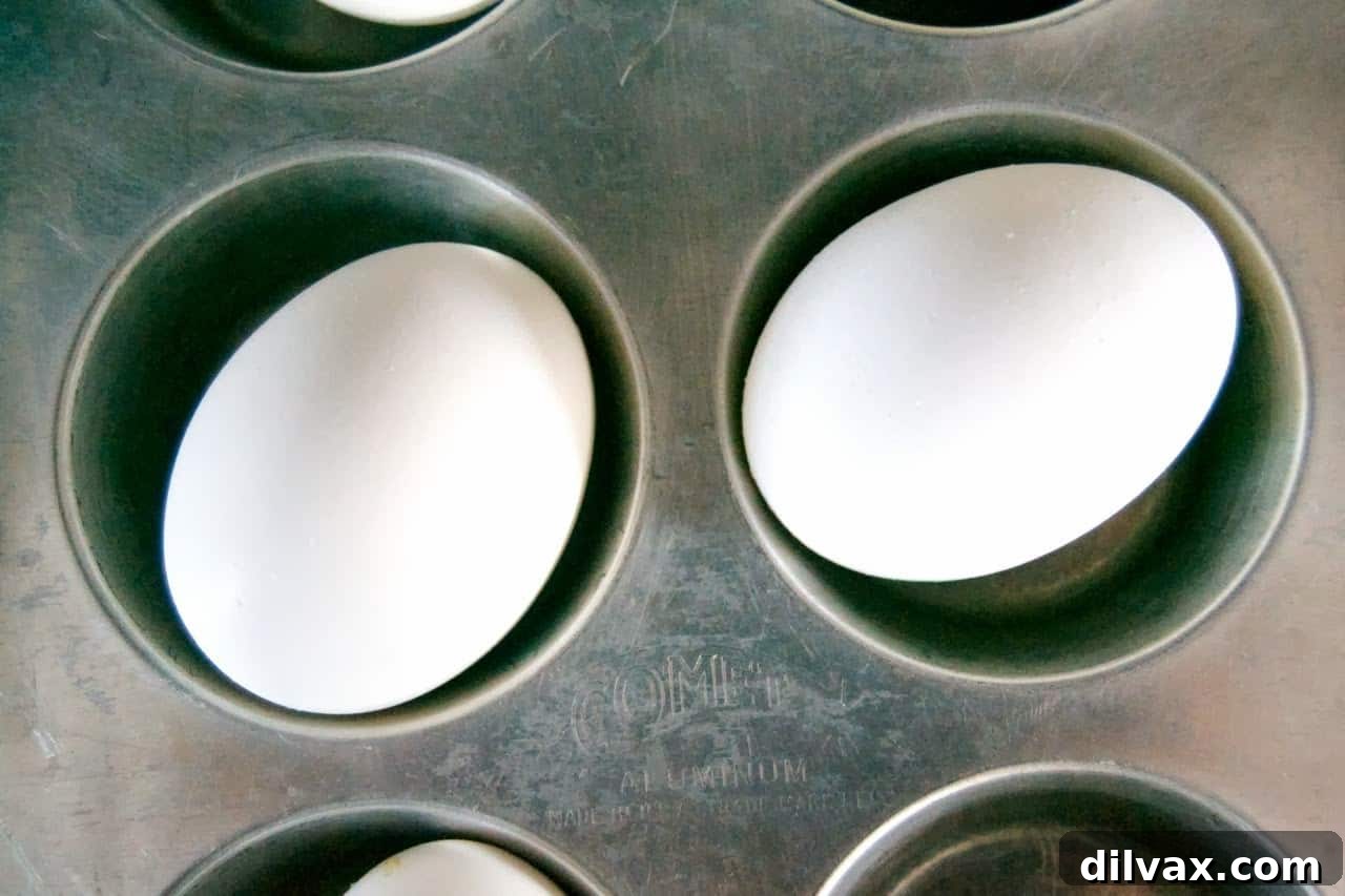 Baked Hard Boiled Eggs 4 Peeled hard-boiled eggs in a bowl