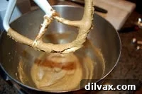 Mixing molasses, shortening, brown sugar, and egg for cookies