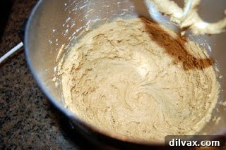 Mixing dry ingredients into the wet molasses cookie dough