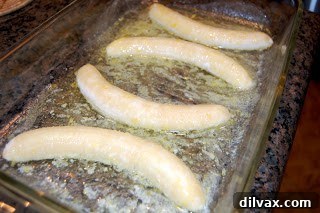 Day 101 Mother's Day Banana Bake 3 Peeled and halved bananas arranged in the butter and lemon mixture in a baking dish