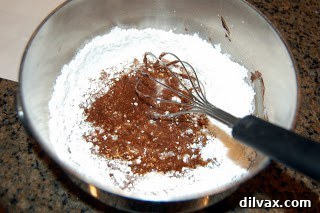 Chocolate frosting being mixed in a bowl