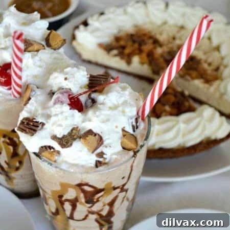 Close up image of Reese's Peanut Butter Creme Pie Shake, topped with whipped cream and chopped Reese's.