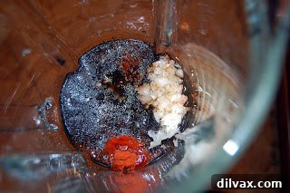 Dressing ingredients for strawberry spinach salad in a blender.