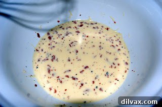 The egg and milk mixture blended with cheese and crispy bacon, ready for spinach.