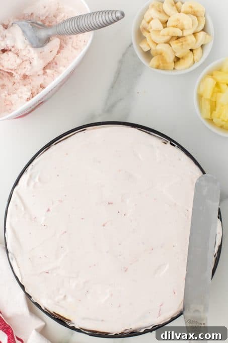 Strawberry ice cream layer in the Banana Split Ice Cream Cake