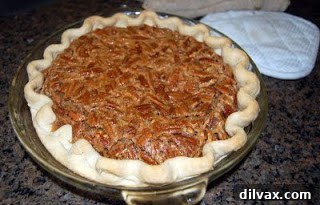 Perfect Pecan Pie 15 Top-down view of a whole Pecan Pie, glistening with syrup and pecans.