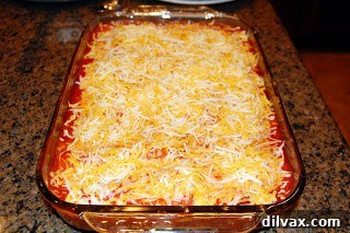 Baking dish with enchiladas after initial covered bake