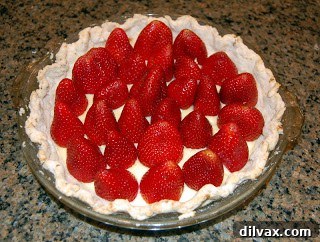 Fresh whole strawberries arranged over the first layer of pie filling