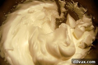 Unlocking the Authentic Sponge Cake 3 Whipped egg whites holding soft peaks, ready for the final sugar addition.