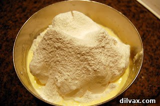 Unlocking the Authentic Sponge Cake 4 Sifting cake flour over the egg white and yolk mixture for a light batter.