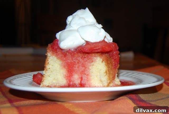 Unlocking the Authentic Sponge Cake 7 True Sponge Cake dusted with confectioners' sugar, adorned with fresh strawberries and whipped cream.