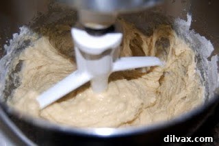 Yeast mixture, eggs, melted butter, and two cups of flour combined into a shaggy dough.