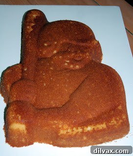 A freshly baked cake being leveled and unmolded onto a cooling rack.