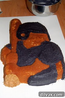 Closeup of the baseball player cake being decorated.