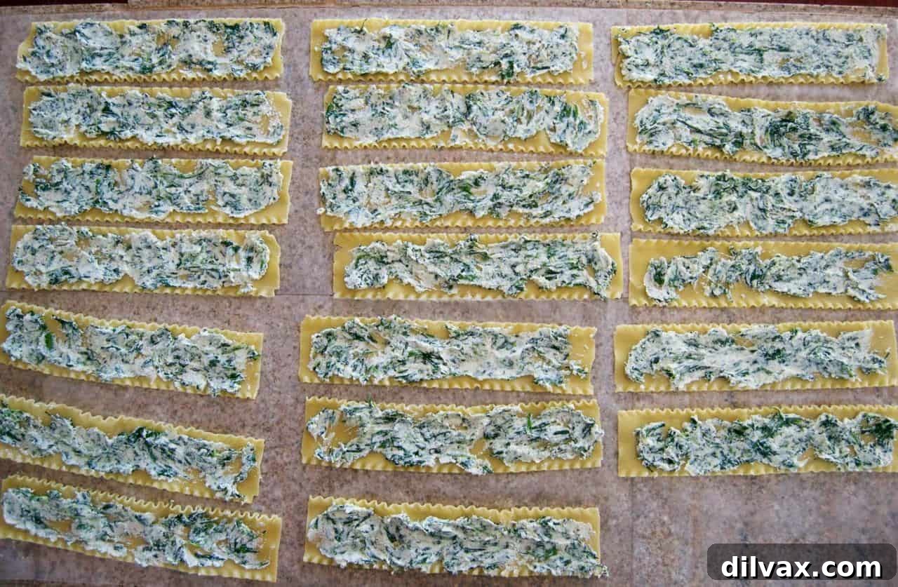 Savory Spinach Ricotta Lasagna Rolls 5 Assembled Spinach Lasagna Roll-Ups neatly arranged in a baking dish with sauce