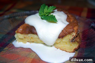 Serving of Orange Marmalade Soufflé with Grand Marnier sauce drizzled over it