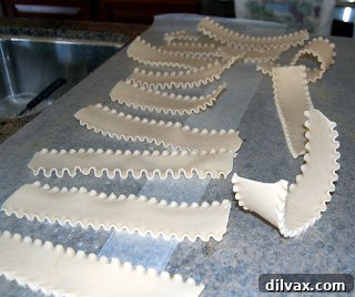 Cooked gluten-free lasagna noodles laid out on wax paper