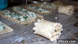Gluten-free lasagna noodle with ricotta and spinach filling spread on it