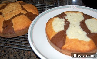 Freshly baked marble cake cooling on a wire rack, ready for frosting.