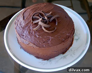 Finished birthday cake with festive candles, beautifully frosted with a store-bought chocolate frosting.