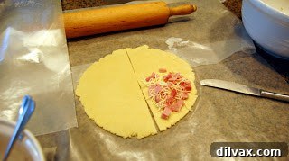 Savory Gluten-Free Ham and Cheese Pockets 4 Gluten-free pie dough with ham and cheese filling on one half.