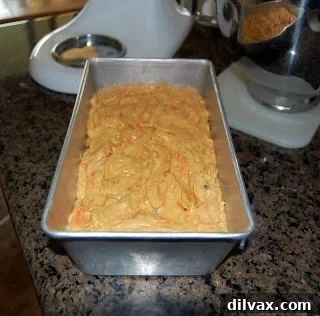 Carrot and raisin bread baking in a loaf pan.