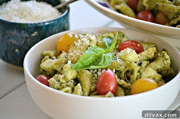 This Pesto Chicken Pasta Salad is pasta, diced chicken, tomatoes and diced mozzarella tossed in an easy pesto. It can also be a side without the chicken!
