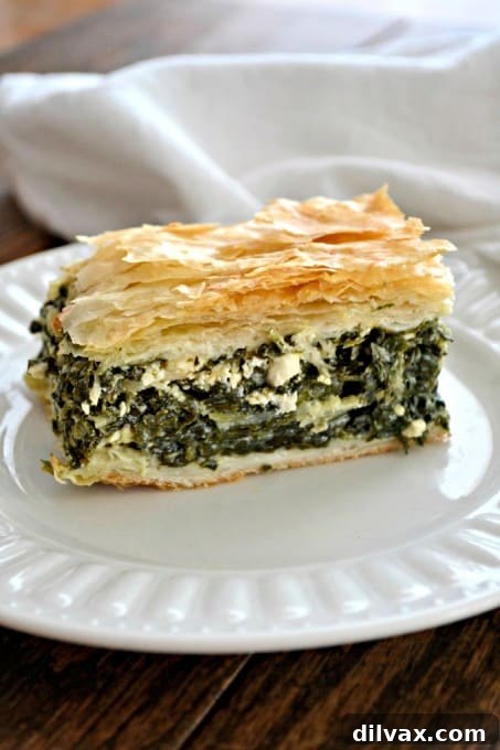 A delicious and satisfying Spanakopita, with a rich filling of spinach, fragrant onion, and herbed Feta cheese, all packed between layers of golden, crispy phyllo dough, making a generous dish perfect for serving everyone.
