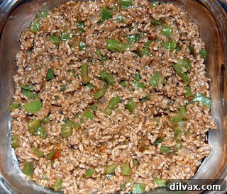 Meat filling spread evenly in a casserole dish.