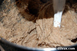 Freshly mixed cinnamon roll dough after its first rise, perfectly proofed and ready for kneading and shaping.