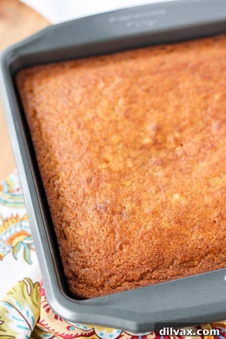 Golden Banana Cake with Velvety Cream Cheese Frosting 5 A freshly baked, unfrosted banana cake cooling on a wire rack.