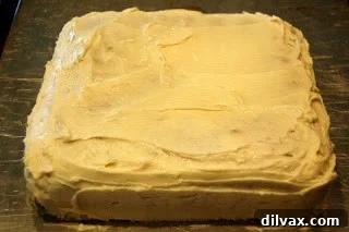 Golden Banana Cake with Velvety Cream Cheese Frosting 9 A top-down view of a freshly baked banana cake in a square pan, ready to be frosted.