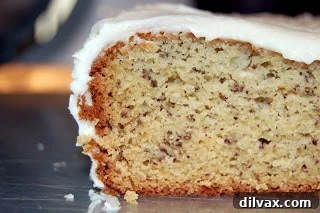 Golden Banana Cake with Velvety Cream Cheese Frosting 10 A close-up of the moist, tender crumb of a slice of banana cake.