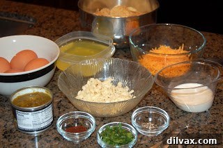Day 21 Chile Cheese Casserole Delight 2 Various ingredients for Chile Cheese Casserole laid out on a kitchen counter, including eggs, spices, cheese, and a bowl of green chiles.