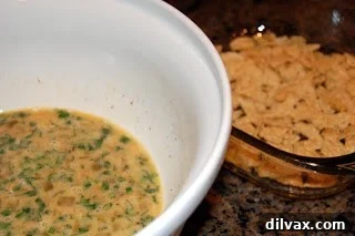 Day 21: Chile Cheese Casserole Magic 4 Crushed tortilla chips forming a base layer in a baking dish, with the final egg and cheese mixture waiting to be poured.