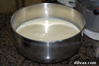 Crème Brûlée custard mixture poured into ramekins for baking Homogeneous mixture of egg yolks, vanilla sugar, and cream ready for pouring