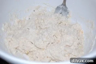 Adding milk to biscuit dough