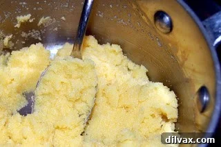 Day 16: Golden Corn Crisps 3 Cornmeal and salt being stirred into boiling water and butter mixture