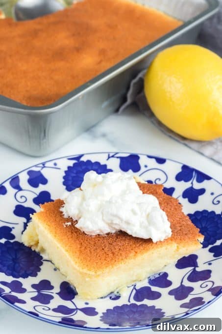 A slice of easy lemon pudding cake dessert on a plate.