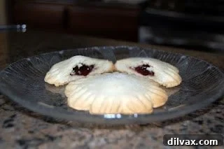 Finished jam-filled sugar cookies on a baking sheet